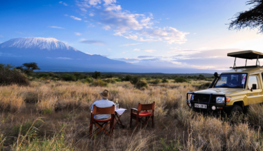 A man sitting a looking at Mount Kilimanjaro at Elerai Camp