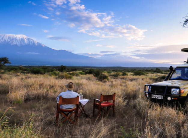 A man sitting a looking at Mount Kilimanjaro at Elerai Camp